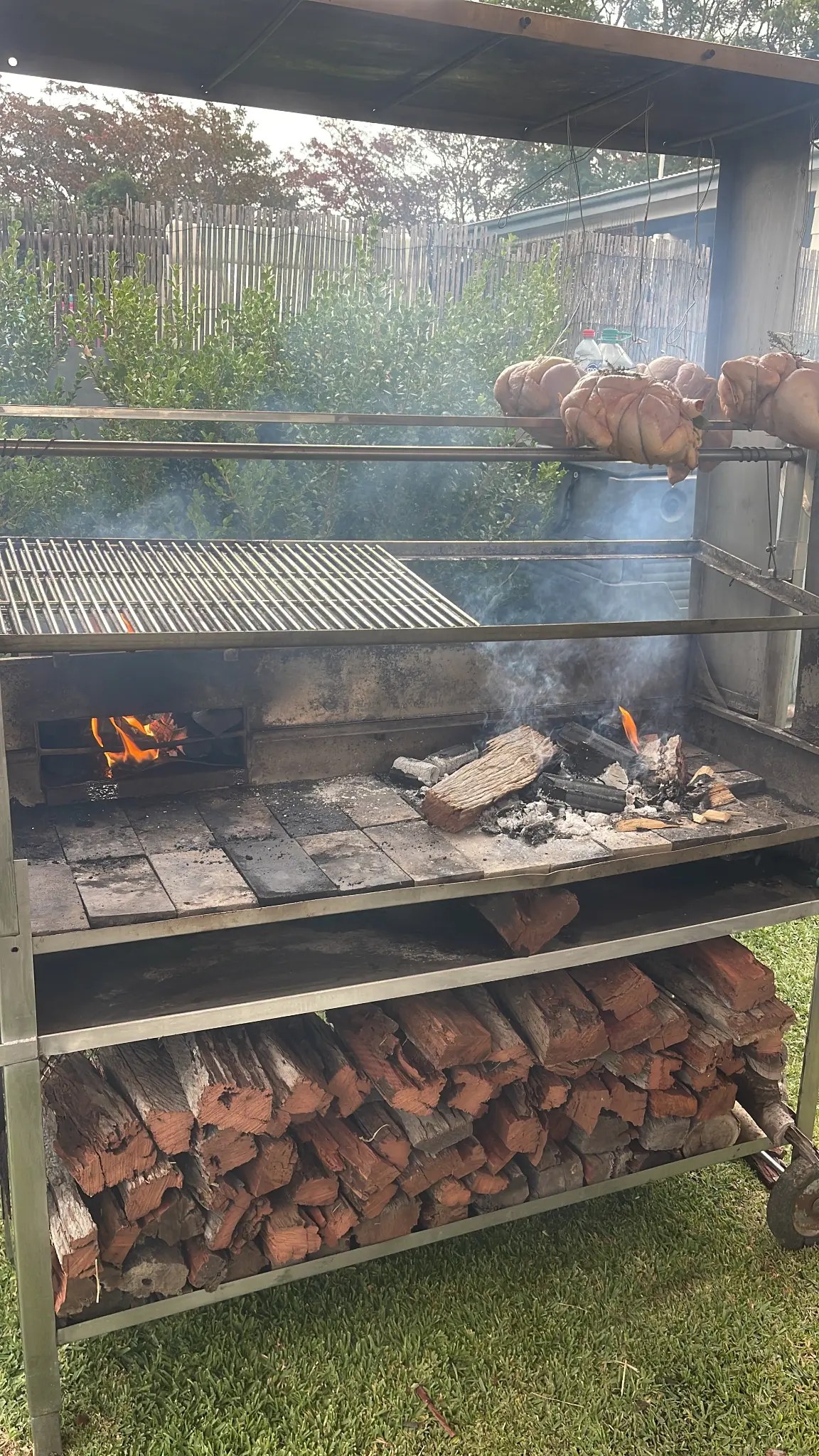 Whole chickens on spit over open wood fire